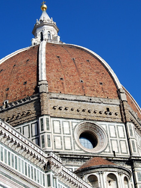 Brunelleschi's Dome on Florence Cathedral under clear blue sky.