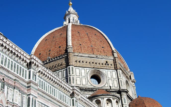 Brunelleschi's Dome on Florence Cathedral under clear blue sky.