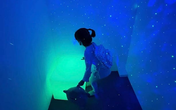 Child exploring glowing interactive exhibit at Otah & Friends Volume 2, Gardens by the Bay.