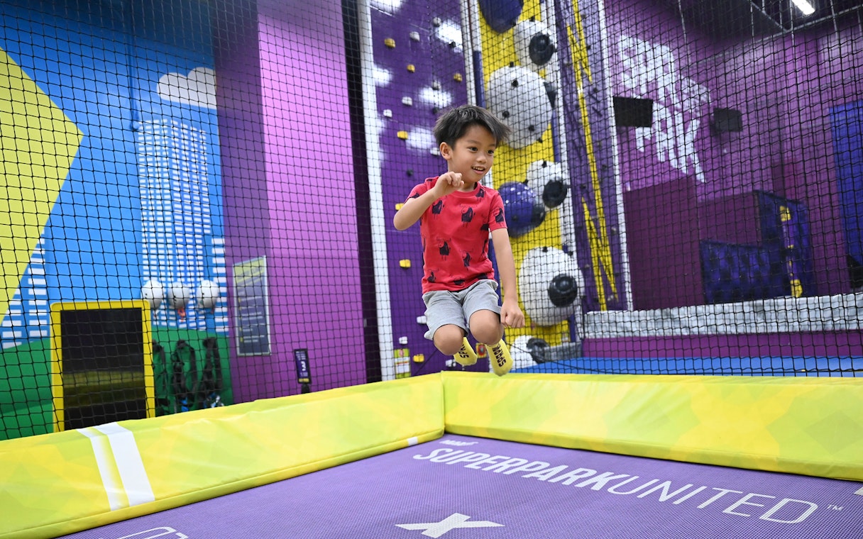 Child jumping on trampoline at SuperPark Singapore indoor playground.