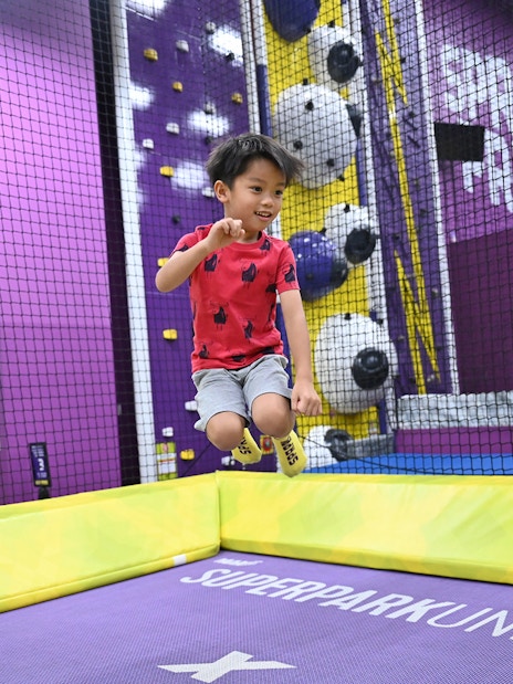 Child jumping on trampoline at SuperPark Singapore indoor playground.