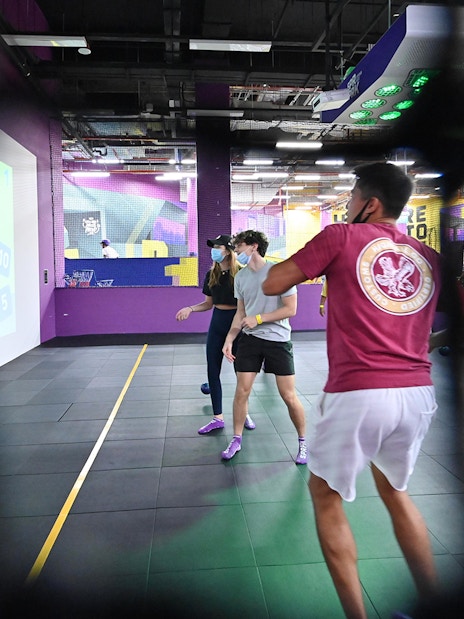 Visitors playing interactive games at SuperPark Singapore indoor activity center.