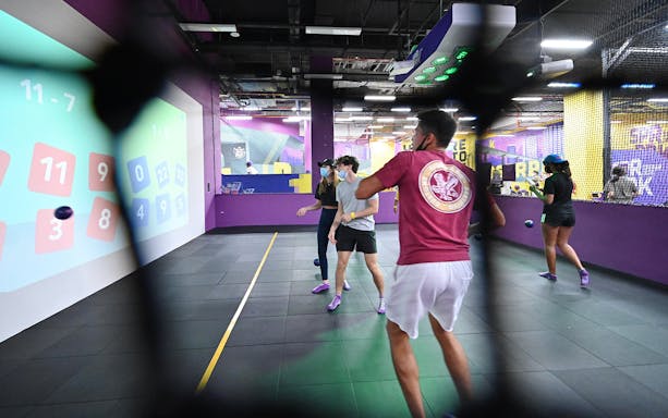 Visitors playing interactive games at SuperPark Singapore indoor activity center.