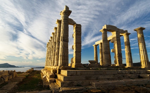 Temple of Poseidon at Cape Sounion with sea view in the background.