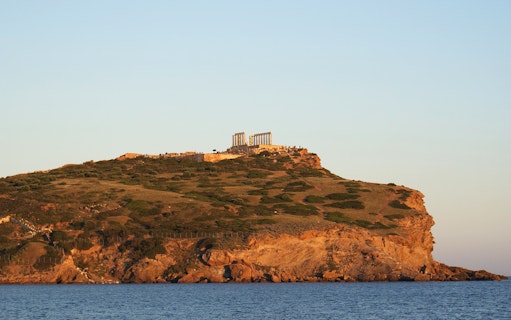 Temple of Poseidon on Cape Sounion hilltop overlooking the Aegean Sea.