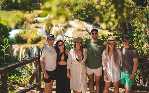 Group of tourists at Krka National Park waterfall during a tour from Split.