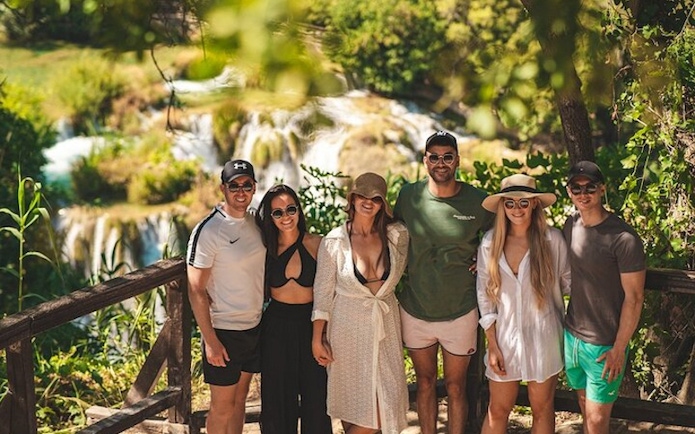 Group of tourists at Krka National Park waterfall during a tour from Split.