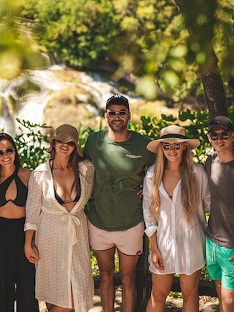 Group of tourists at Krka National Park waterfall during a tour from Split.