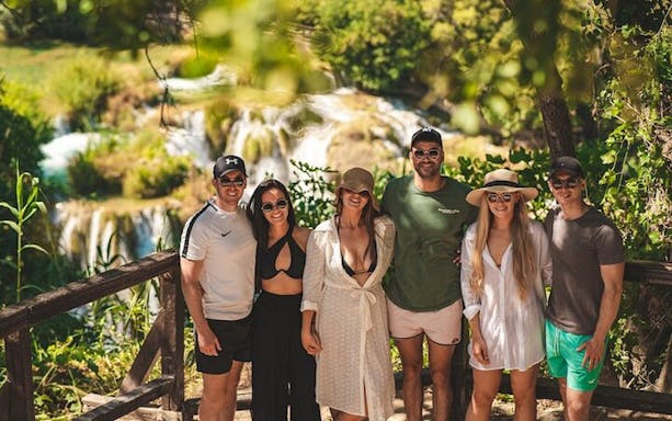 Group of tourists at Krka National Park waterfall during a tour from Split.