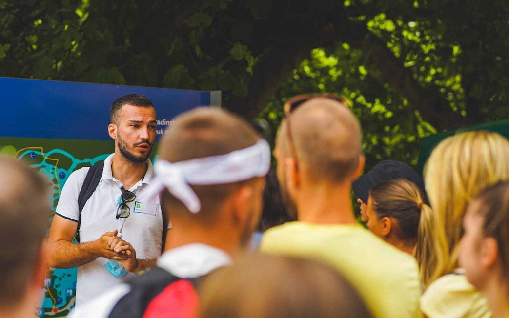 Tour guide explaining Krka National Park map to visitors from Split.
