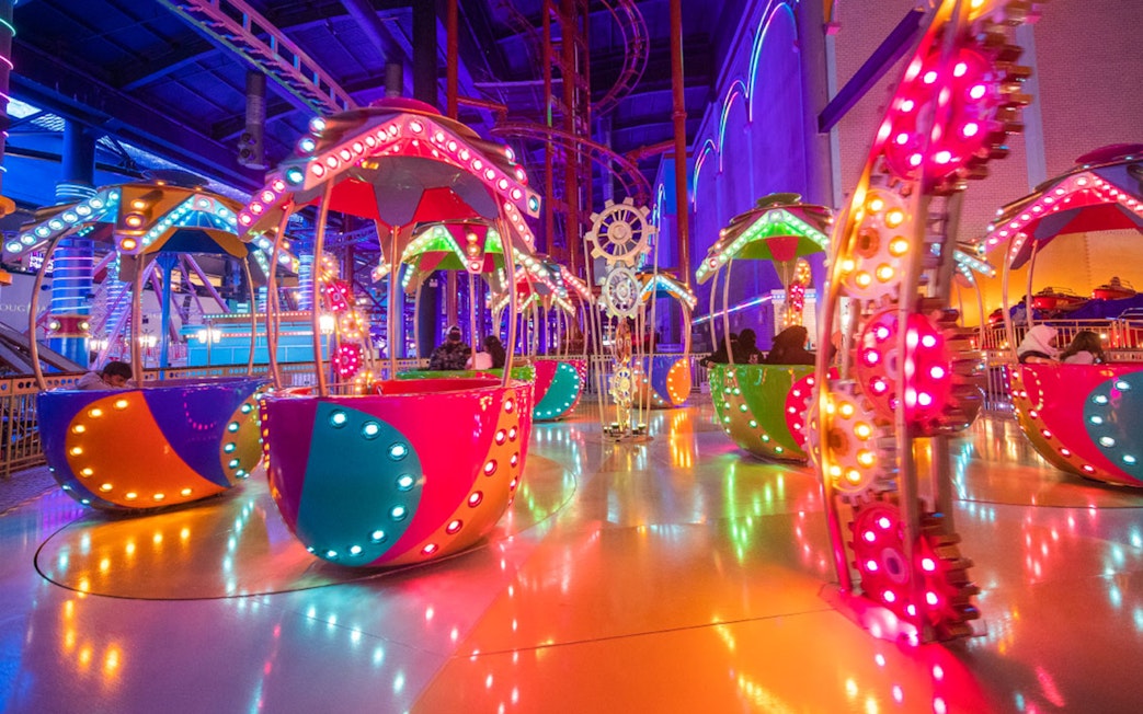Colorful rides at Skytropolis Theme Park, vibrant lights and spinning attractions.