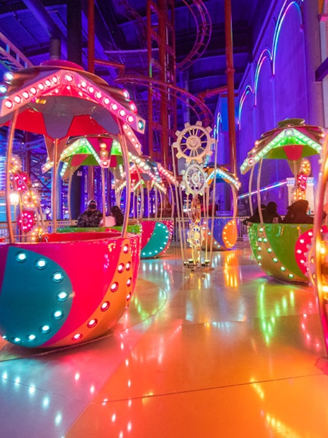 Colorful rides at Skytropolis Theme Park, vibrant lights and spinning attractions.