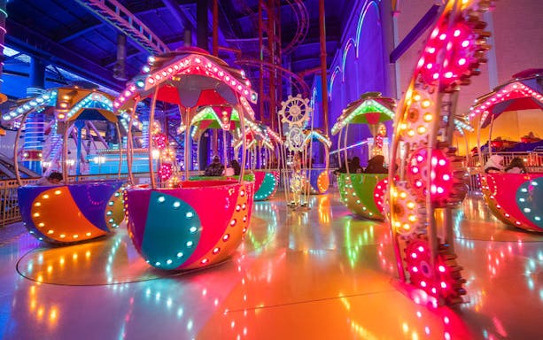 Colorful rides at Skytropolis Theme Park, vibrant lights and spinning attractions.