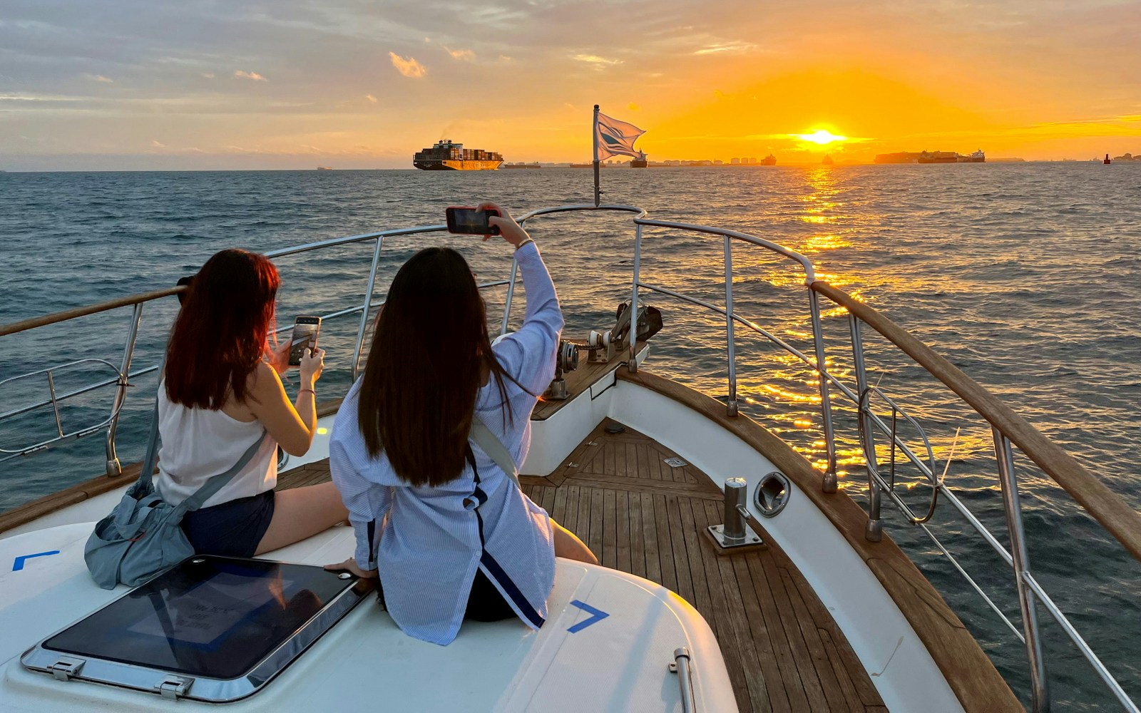 Sunset sail with city skyline view, featuring iconic landmarks on a cruise.