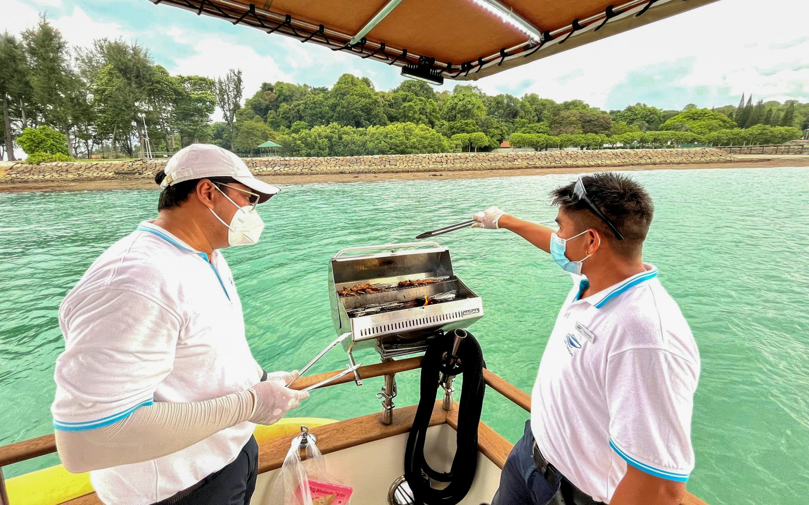 Sunset cruise with BBQ overlooking city skyline and waterfront.