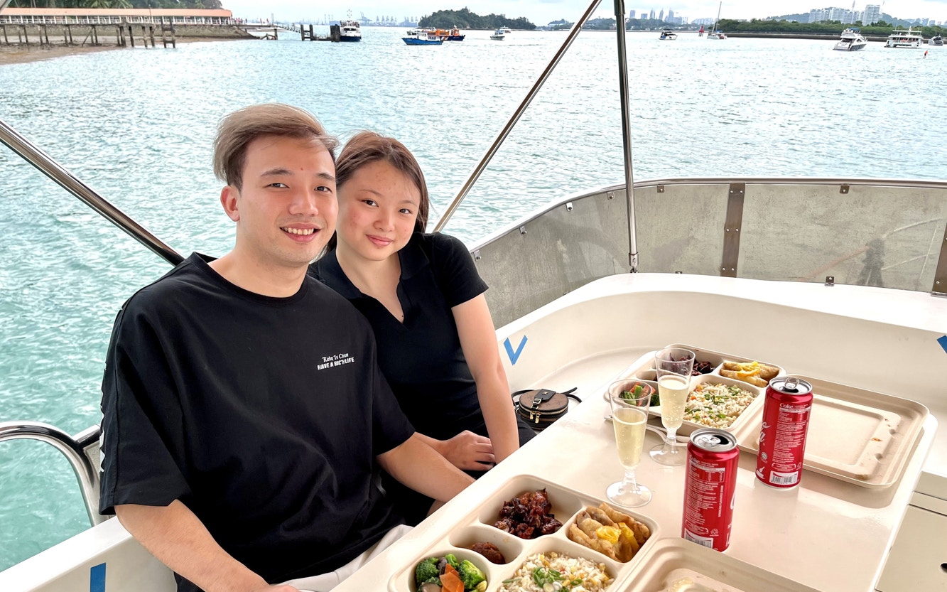 City skyline view from a sunset cruise with BBQ, featuring iconic landmarks.