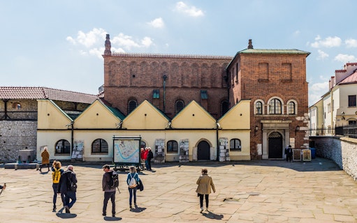 Tourists exploring the Old Synagogue in Kazimierz, Krakow's Jewish Quarter.