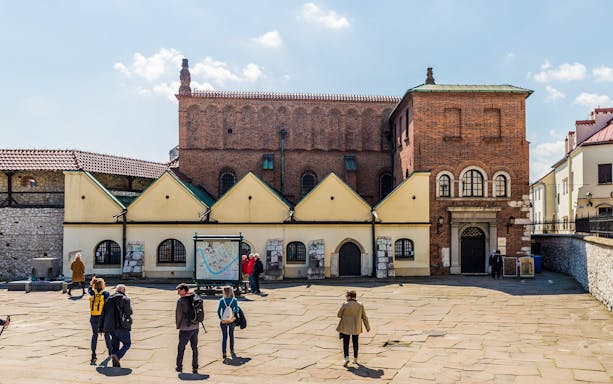 Tourists exploring the Old Synagogue in Kazimierz, Krakow's Jewish Quarter.
