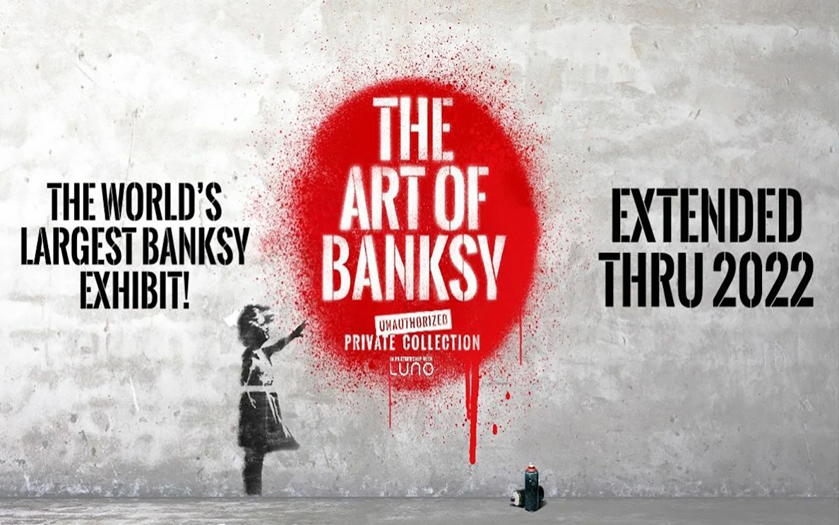 The Art of Banksy exhibit poster with red spray paint and girl stencil.