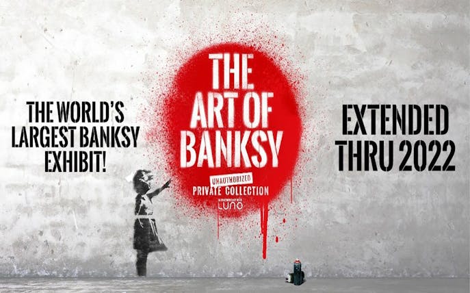 The Art of Banksy exhibit poster with red spray paint and girl stencil.
