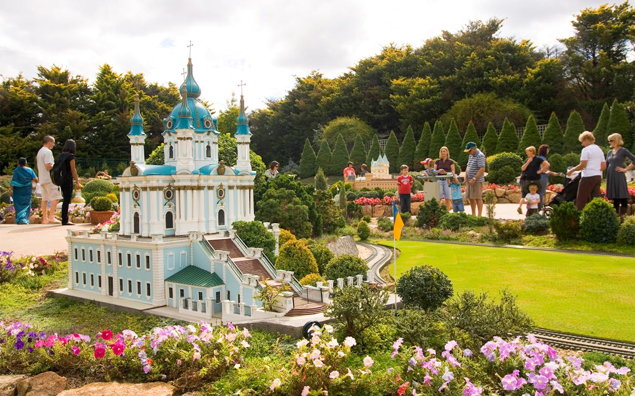 Miniature building and visitors at Cockington Green Gardens, Canberra.