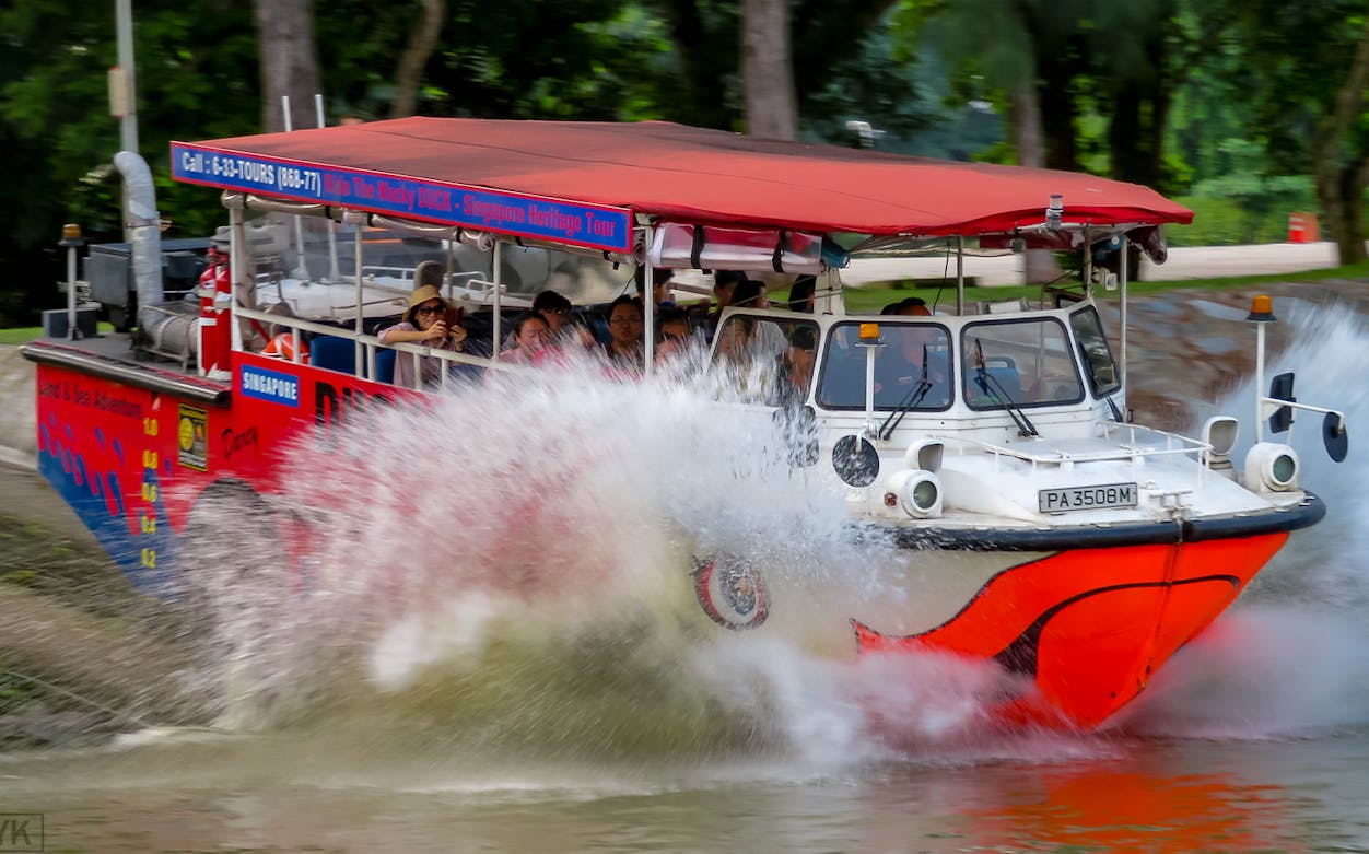 Amphibious vehicle splashing into water during Singapore DUCKtours.
