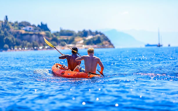 Sea kayaking near Split with two people paddling in clear blue water.