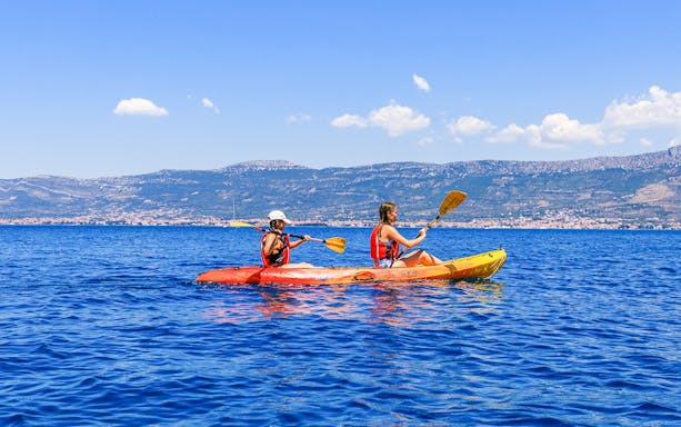 Sea kayaking near Split with mountains in the background.