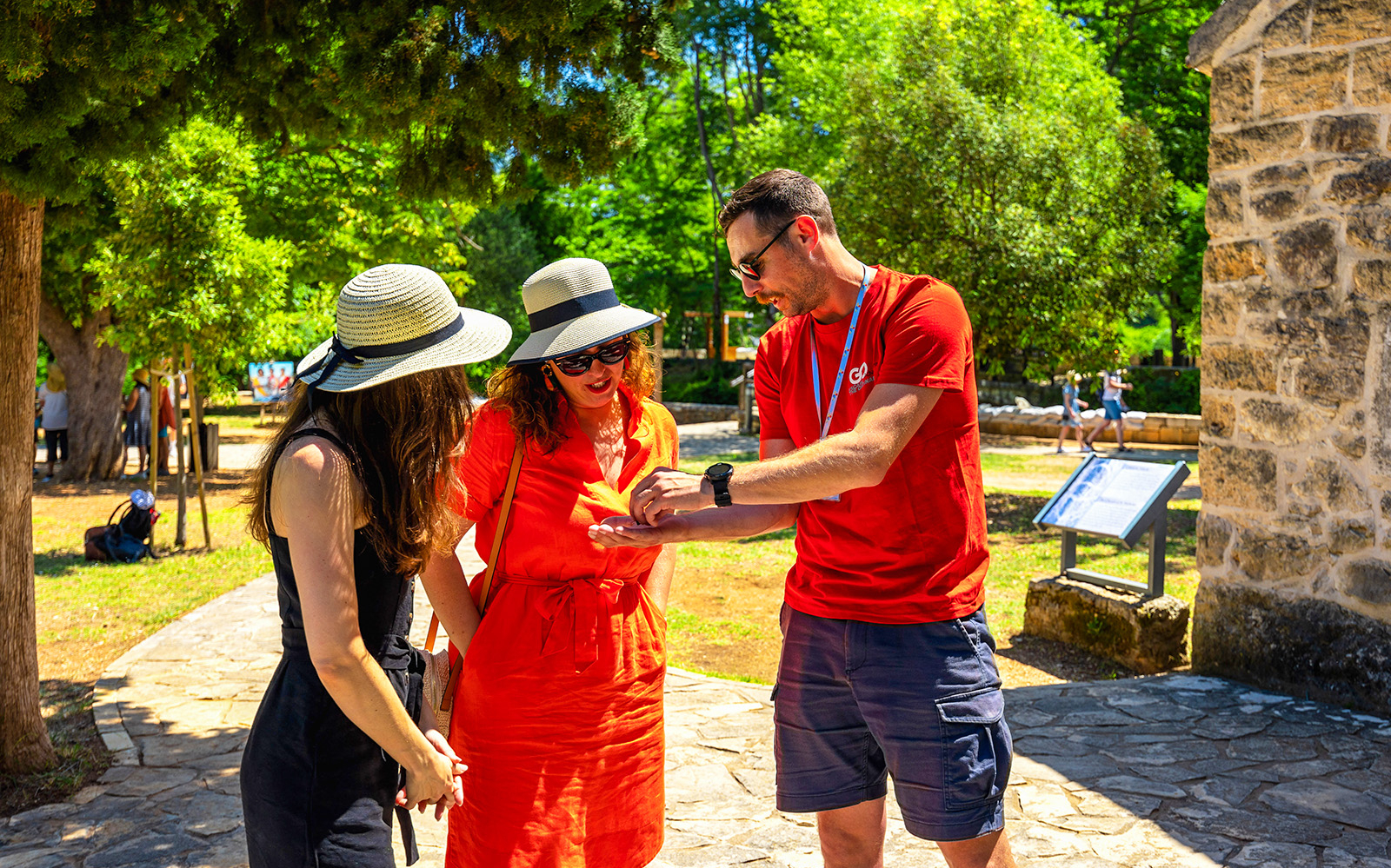 Tour guide explaining details to visitors during KRKA waterfalls tour from Split.