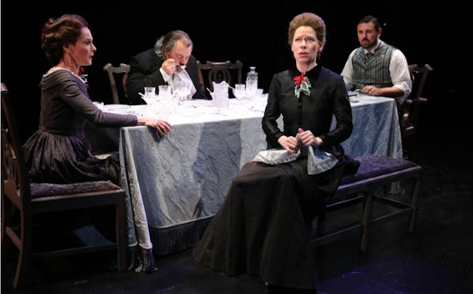 Victorian-era dinner scene from "A Wilder Christmas" play with four actors at a table.
