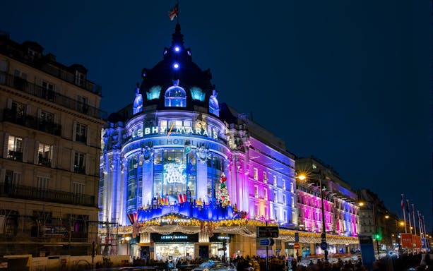 Le BHV Marais department store illuminated at night during Le Marais Walking Tour, Paris.