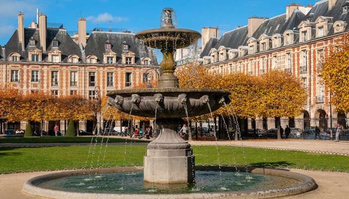 Le Marais Parisian street scene with historic architecture and local shops.