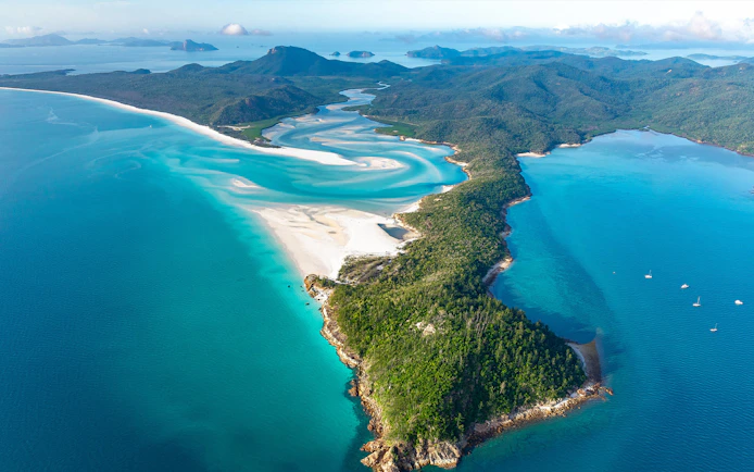 Aerial view of Whitsundays' turquoise waters and white sand beaches during a scenic flight.