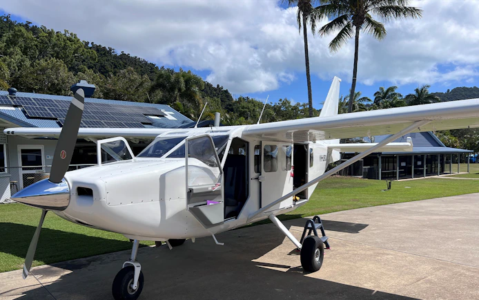 Small aircraft on tarmac for Whitsundays Ocean Rafting scenic flight.