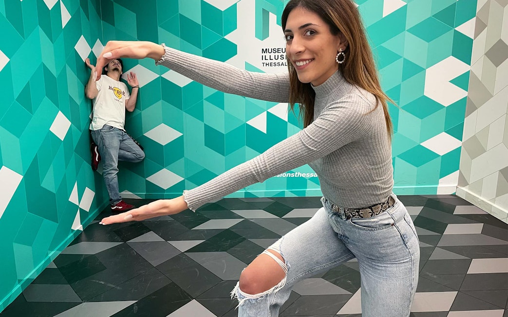 Visitors interacting with optical illusions at the Museum of Illusions Thessaloniki.