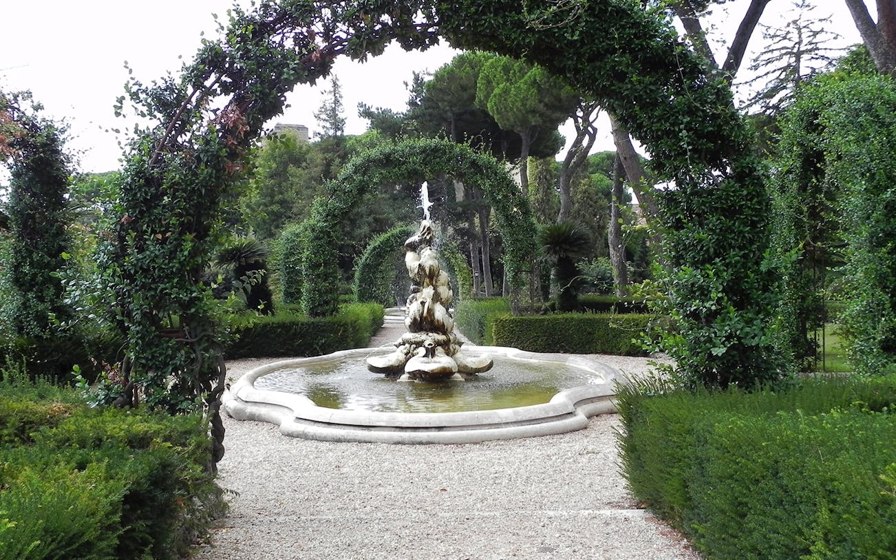 Fountain and archway in Vatican Gardens, Rome, on guided tour to St. Peter's Basilica.