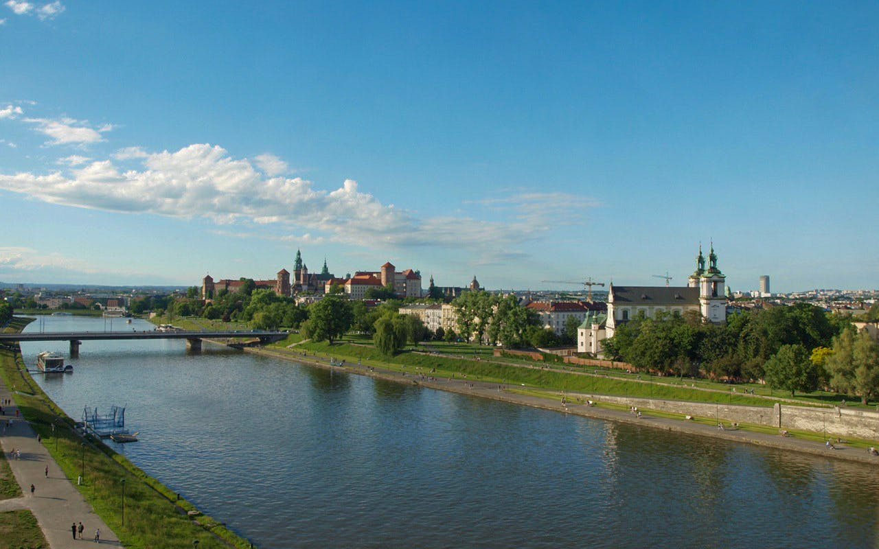 Vistula River with Wawel Castle and Krakow skyline in the background.