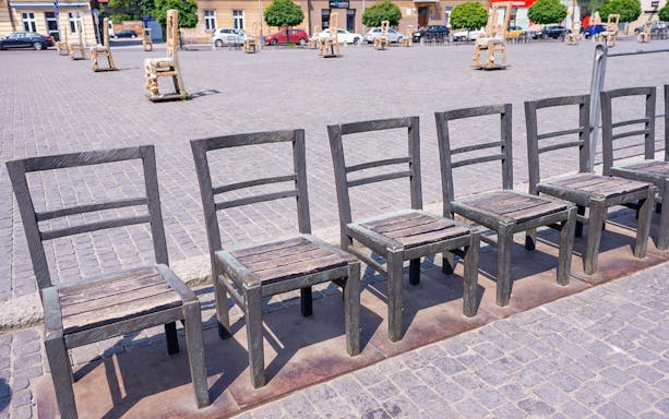 Chairs at Ghetto Heroes Square memorial in Krakow, part of the guided walk tour.