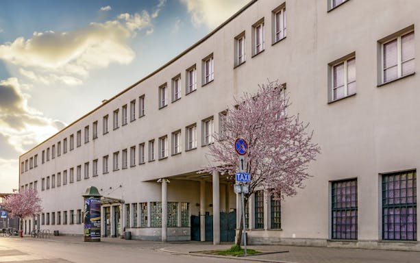 Former Plaszow concentration camp building with blooming trees, Krakow, Poland.