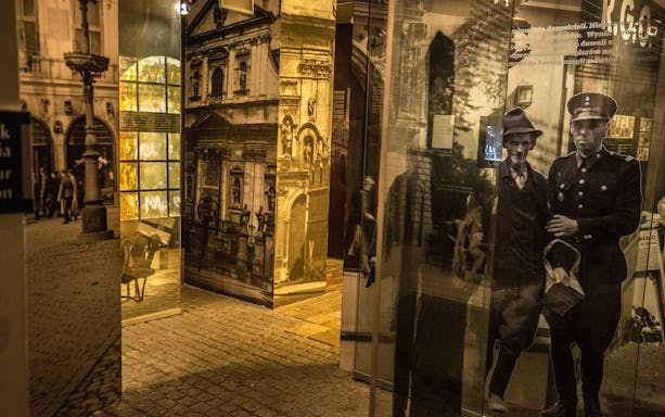 Exhibit of historical photographs and artifacts at Plaszow concentration camp museum.