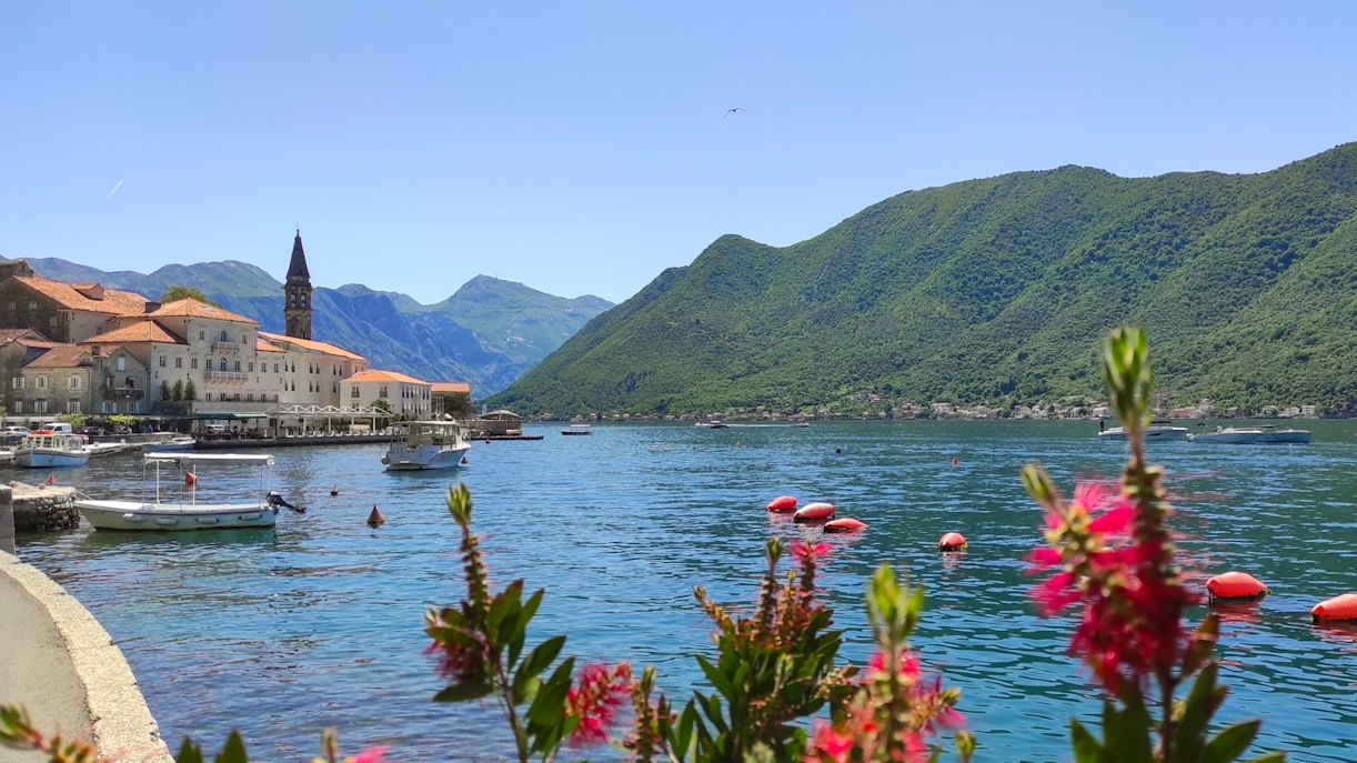 Perast Old Town with Our Lady of the Rocks in Kotor Bay, Montenegro, viewed from a speedboat.