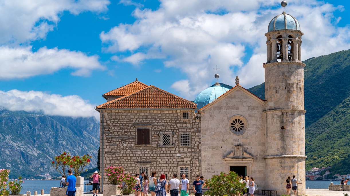 Our Lady of the Rocks church with tourists, Kotor Bay, Montenegro.