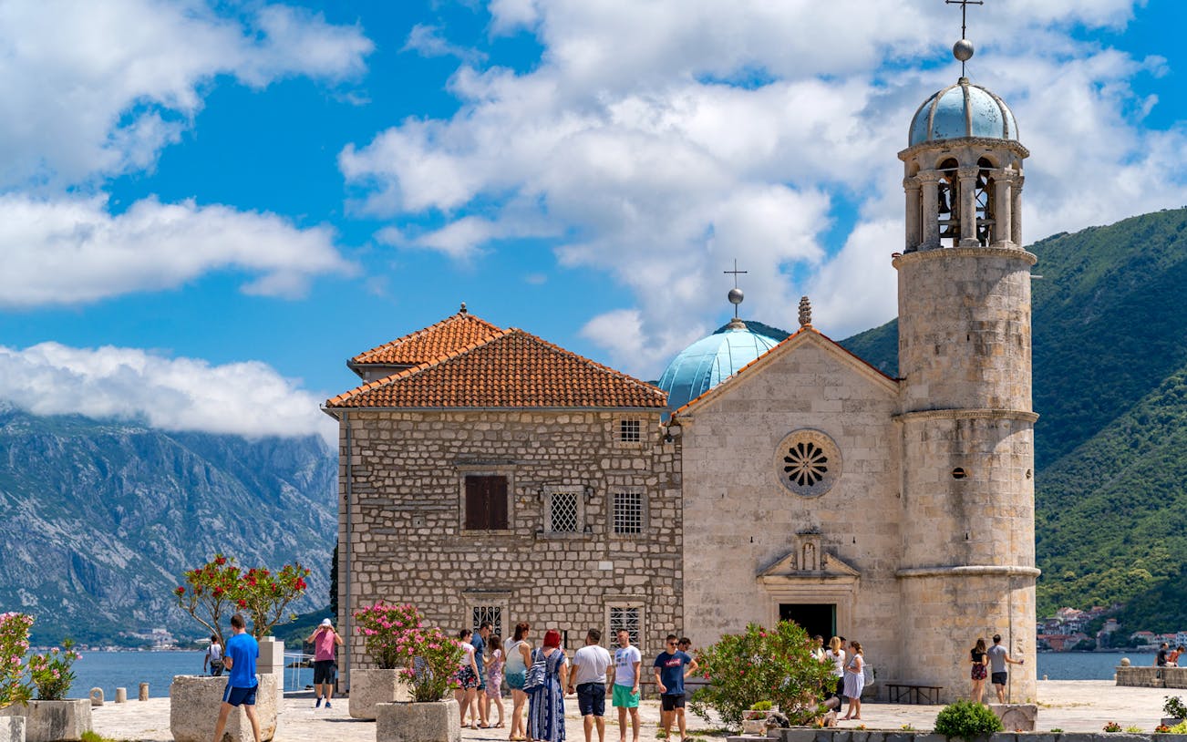 Our Lady of the Rocks church with tourists, Kotor Bay, Montenegro.