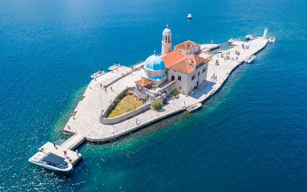 Our Lady of the Rocks island with church in Kotor Bay, Montenegro, viewed from a speedboat.