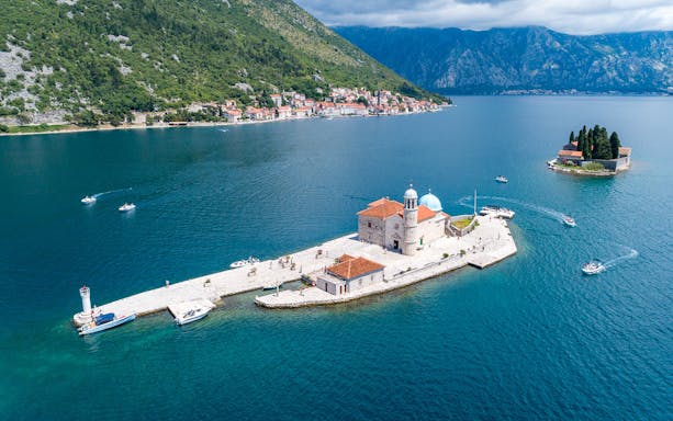 Private speedboats near Our Lady of the Rocks island in Kotor Bay, Montenegro.