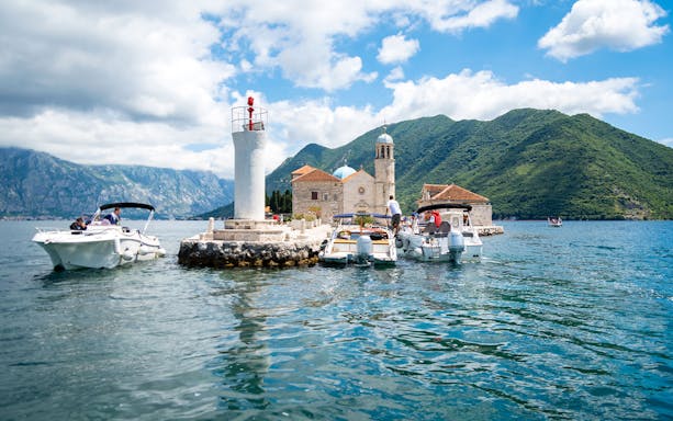 Private speedboat near Our Lady of the Rocks island in Kotor Bay, Montenegro.