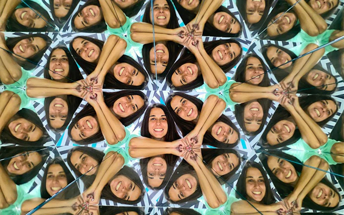 Person reflected multiple times in mirrors at Museum of Illusions, Thessaloniki.