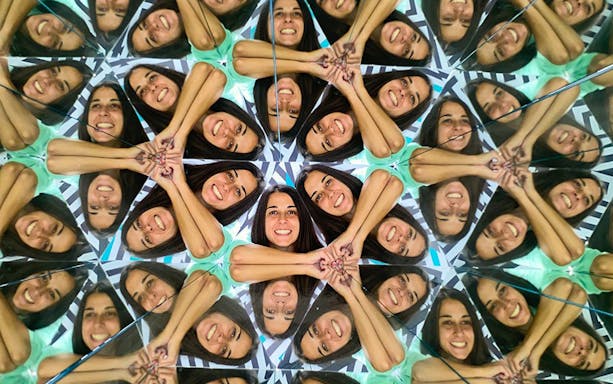 Person reflected multiple times in mirrors at Museum of Illusions, Thessaloniki.