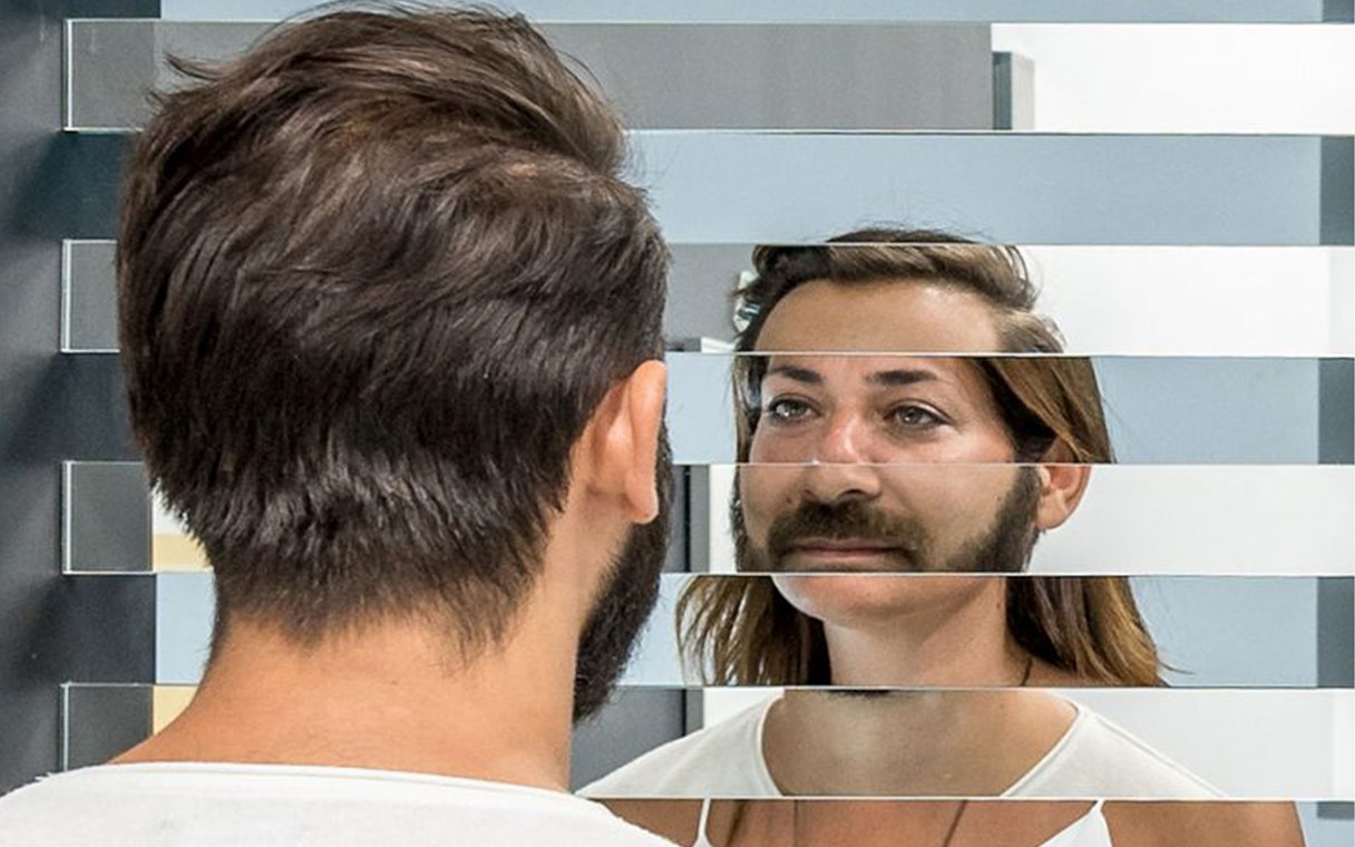 Visitor experiencing optical illusion at Museum of Illusions, Thessaloniki.