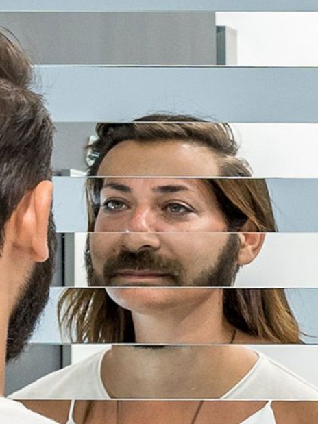 Visitor experiencing optical illusion at Museum of Illusions, Thessaloniki.